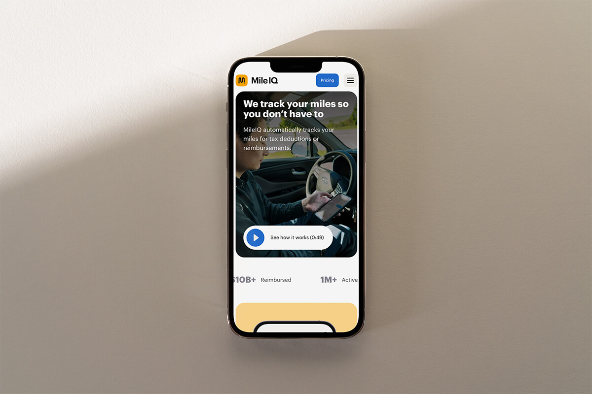 MileIQ mileage tracking website displayed on a phone